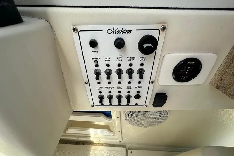 Slide: The Image of Control panel of 2004 Medeiros Limestone 24 Cuddy Cabin boat with various switches. - 34