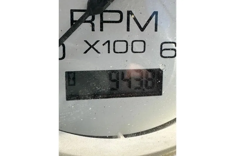 Slide: The Image of RPM gauge displaying 943.6 hours on a 2004 Medeiros Limestone 24 Cuddy Cabin. - 35