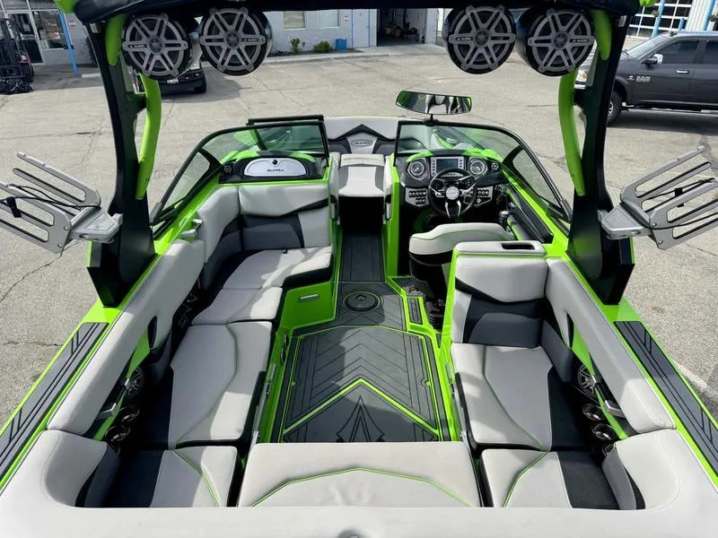 Slide: The Image of 2018 Supra SA450 boat interior with green accents, advanced dashboard, and spacious seating. - 11