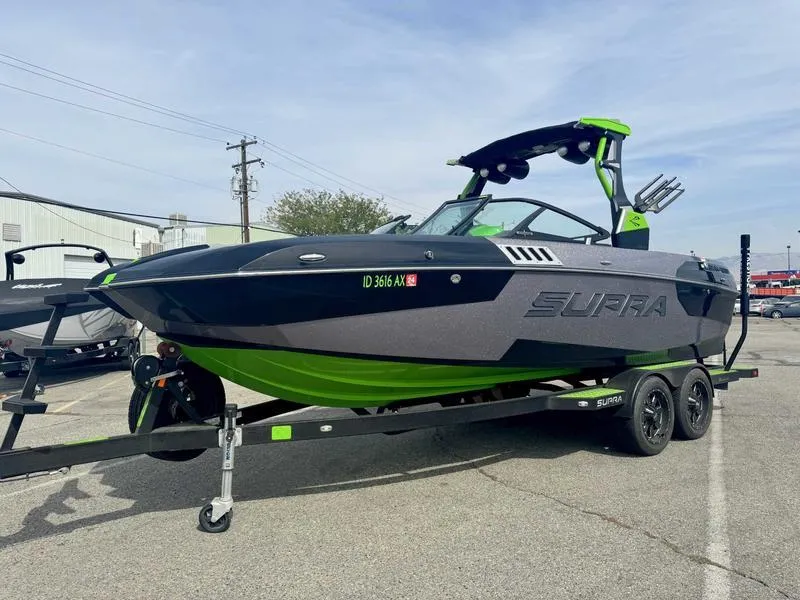 Slide: The Image of 2018 Supra SA450 boat on trailer, featuring sleek design and vibrant green accents. - 15