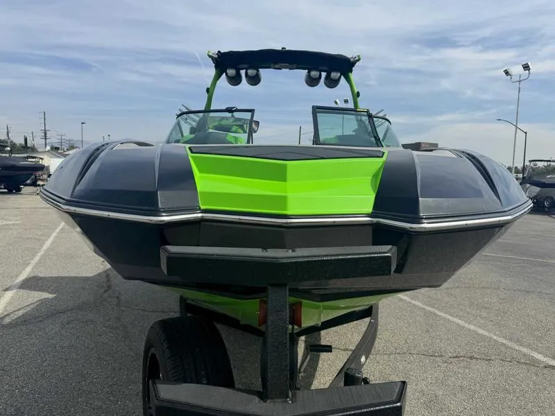 Slide: The Image of 2018 Supra SA450 boat with vibrant green and black design, parked on a trailer. - 6