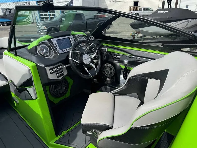 Slide: The Image of 2018 Supra SA450 boat interior with green accents and advanced dashboard controls. - 9