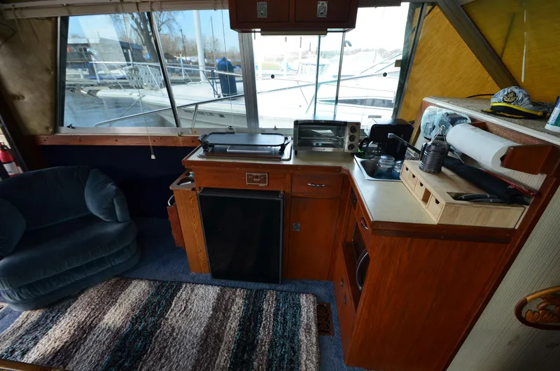 Slide: The Image of 1975 Bayliner Montego boat interior with kitchen and seating area. - 10