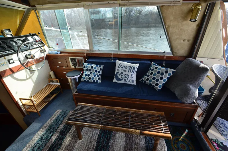 Slide: The Image of Interior of 1975 Bayliner Montego boat with cozy seating and decorative pillows. - 11