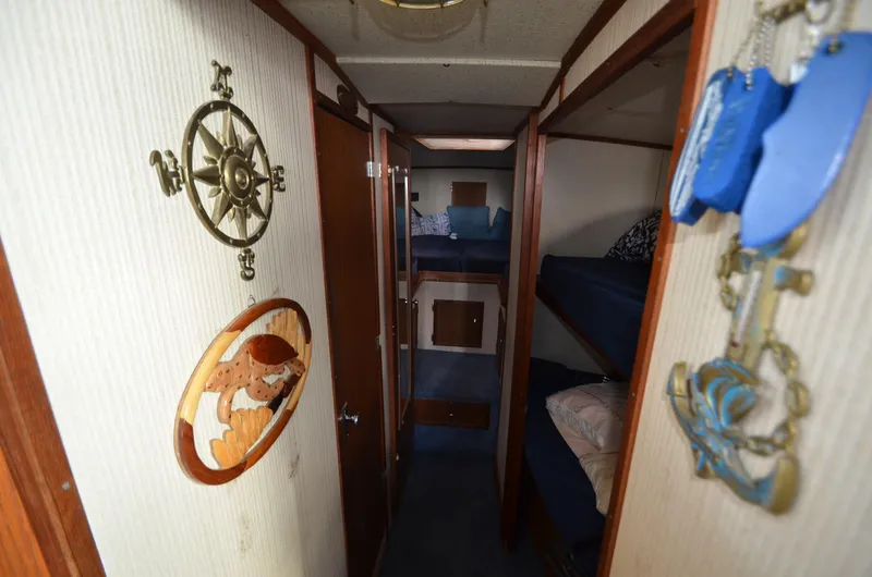 Slide: The Image of 1975 Bayliner Montego interior with nautical decor and bunk beds. - 13