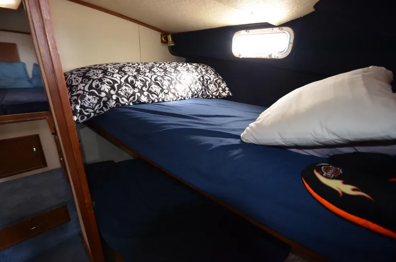 Slide: The Image of 1975 Bayliner Montego cabin with cozy bed and window. - 14