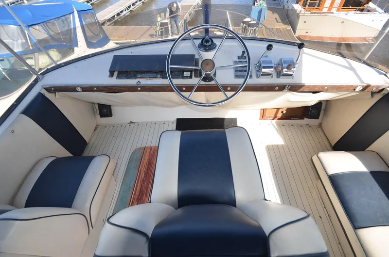 Slide: The Image of 1975 Bayliner Montego boat cockpit with steering wheel and seating. - 19