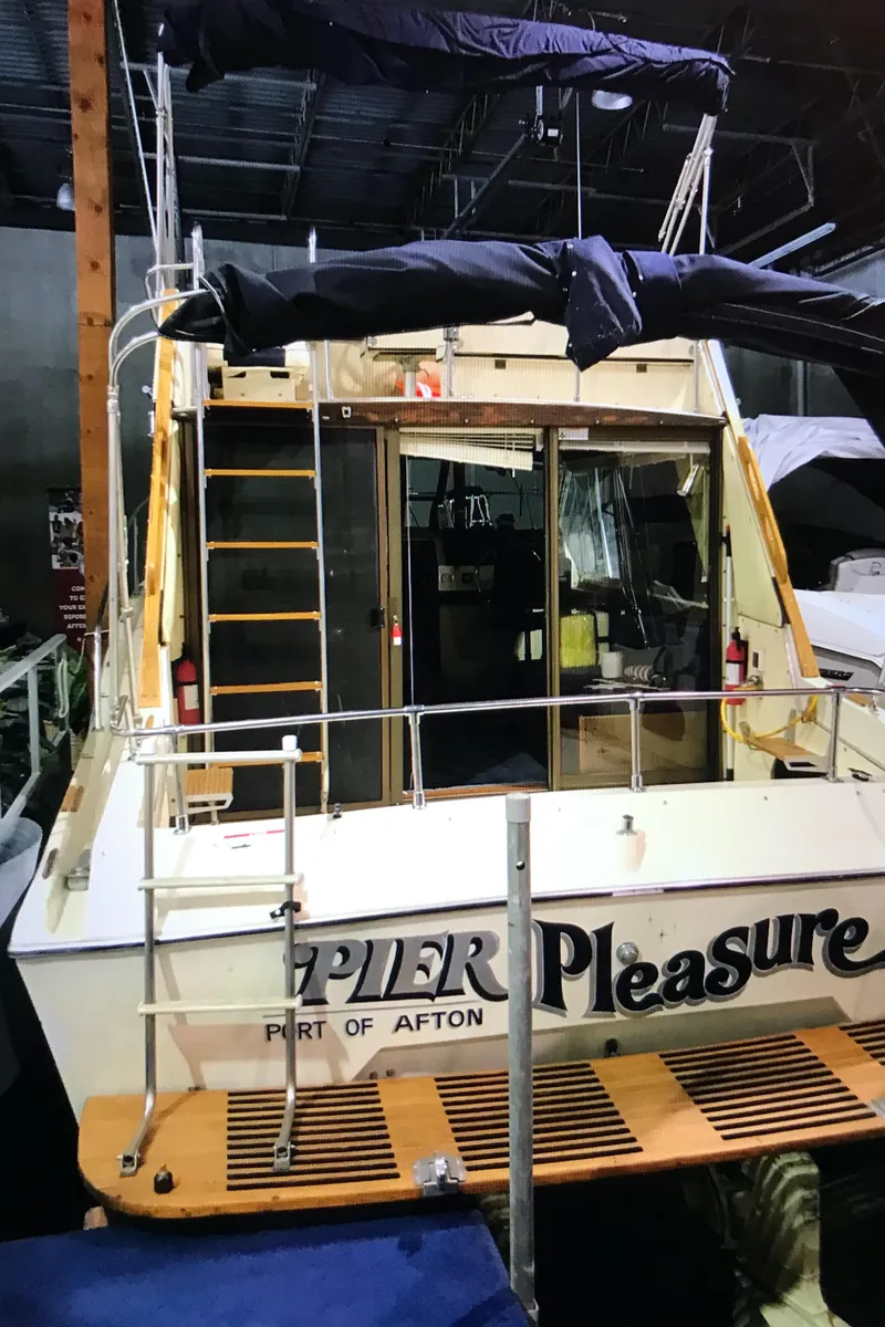 Slide: The Image of 1975 Bayliner Montego boat docked indoors with Pier Pleasure name. - 2