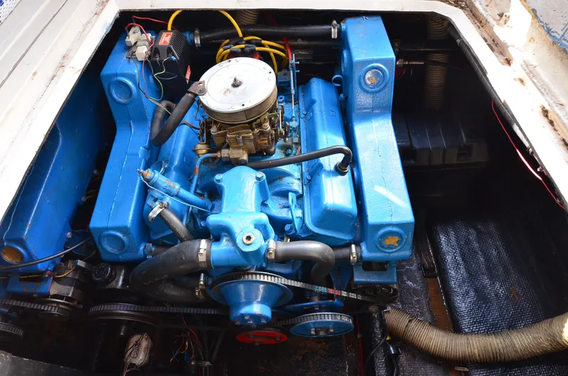 Slide: The Image of 1975 Bayliner Montego engine compartment with blue engine components. - 22