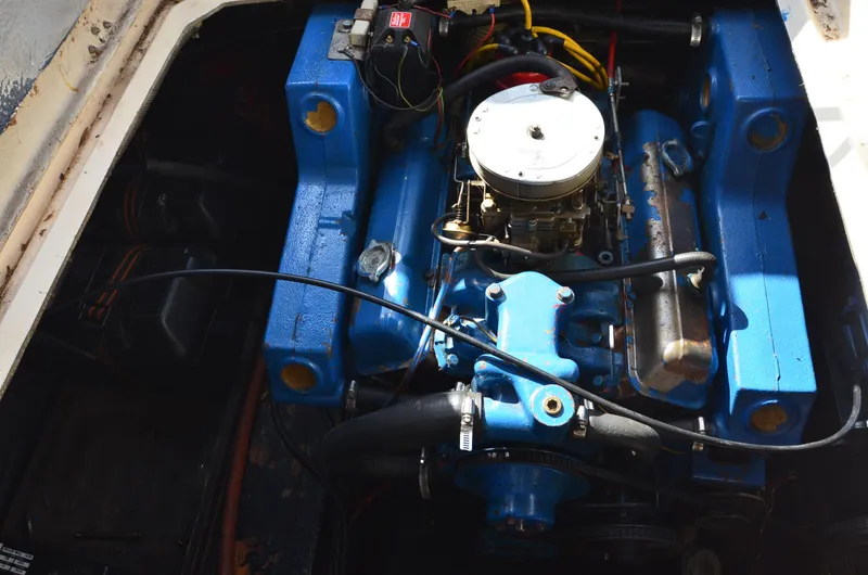 Slide: The Image of 1975 Bayliner Montego engine compartment with blue engine and wiring. - 23