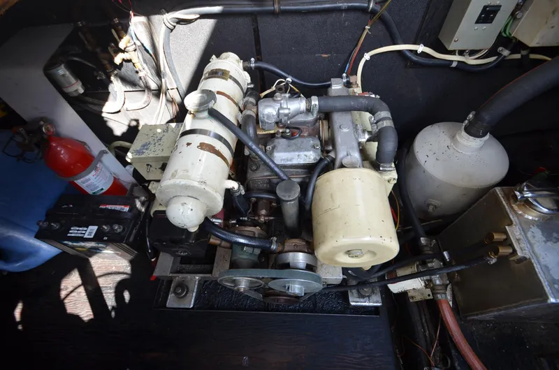 Slide: The Image of 1975 Bayliner Montego engine compartment with visible components and wiring. - 25