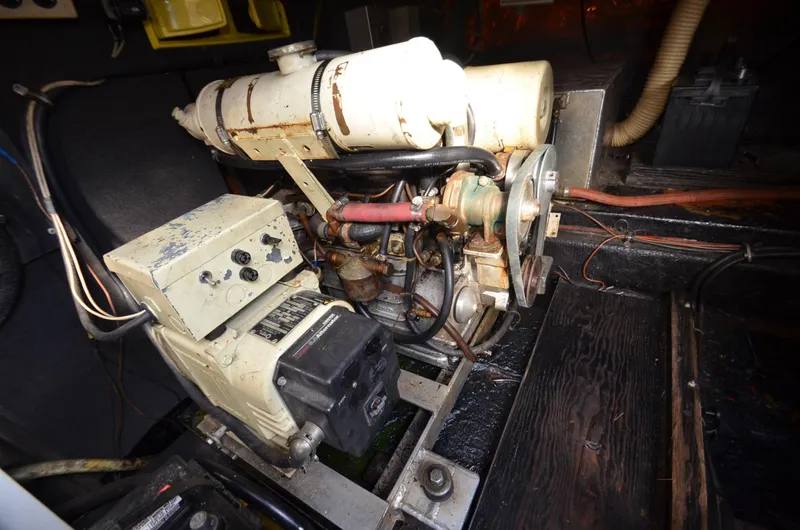 Slide: The Image of 1975 Bayliner Montego engine compartment with visible mechanical components. - 26