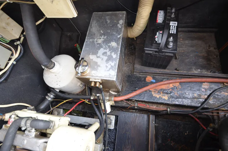 Slide: The Image of 1975 Bayliner Montego engine compartment with battery and mechanical components. - 27