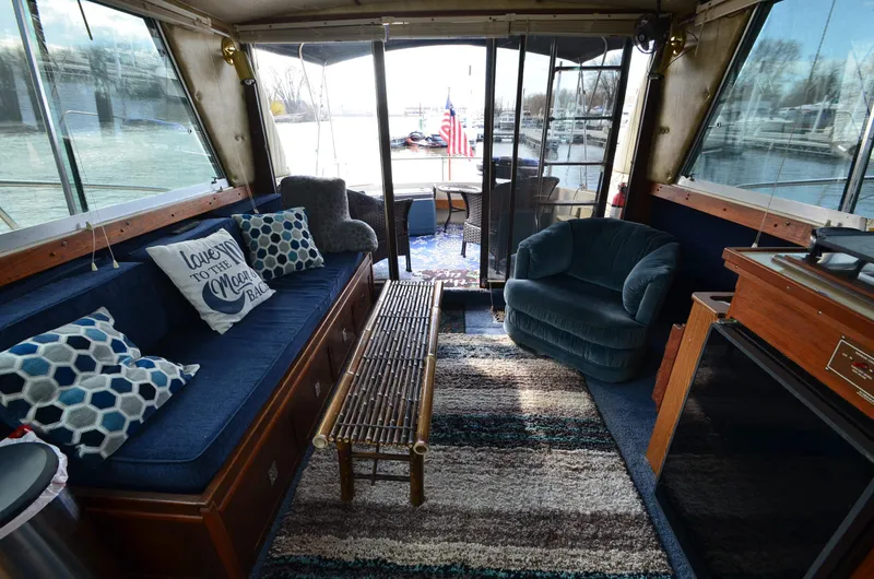 Slide: The Image of Interior of a 1975 Bayliner Montego boat with cozy seating and decorative pillows. - 8