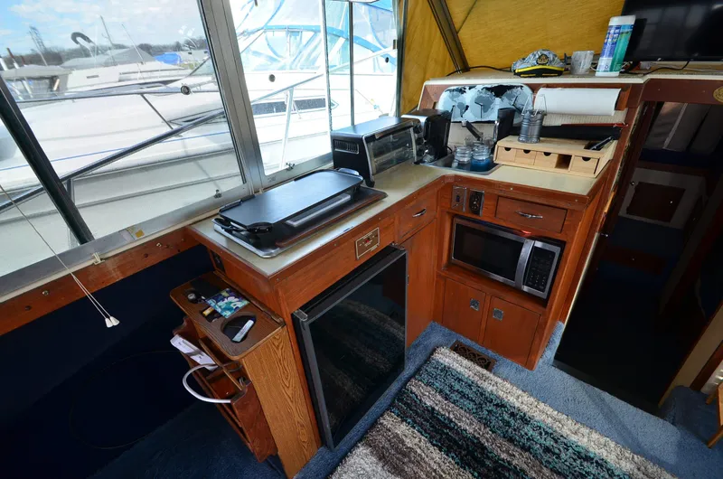 Slide: The Image of 1975 Bayliner Montego boat kitchen with appliances and wooden cabinetry. - 9
