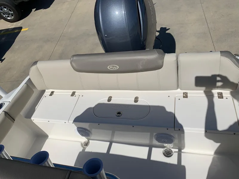 Slide: The Image of 2024 Key West 219 FS boat interior with cushioned seating and storage compartments. - 14