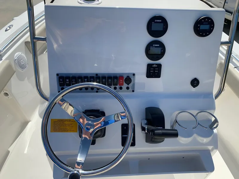 Slide: The Image of 2024 Key West 219 FS boat dashboard with steering wheel and control panel. - 16