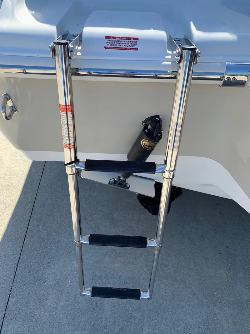 Slide: The Image of 2024 Key West 219 FS boat with a stainless steel boarding ladder. - 7
