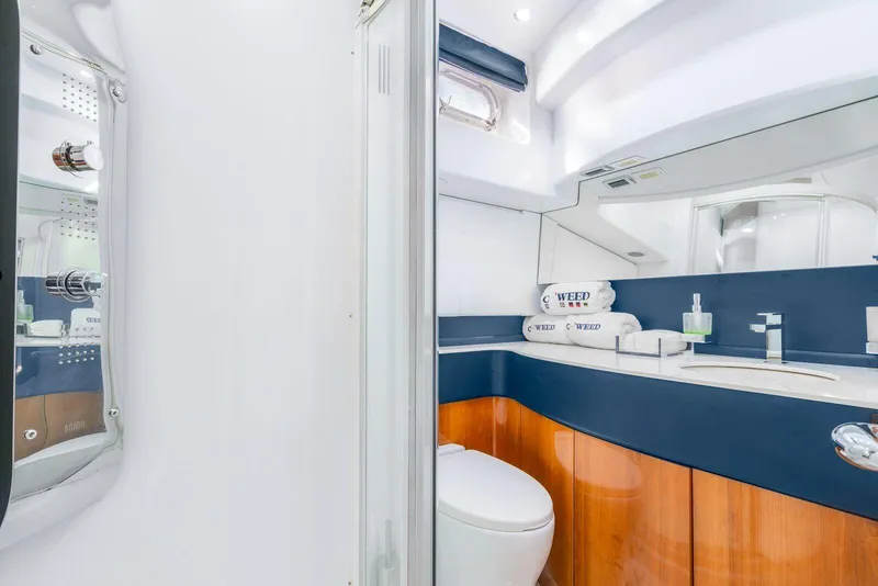 Slide: The Image of Luxurious bathroom on a 2001 Azimut Sea Jet yacht with modern fixtures and wooden cabinetry. - 7
