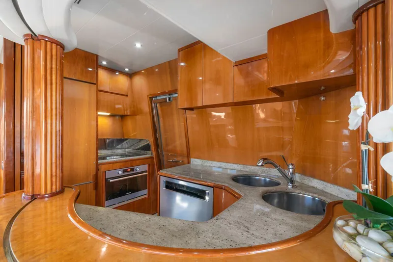 Slide: The Image of Luxurious kitchen interior of 2001 Azimut Sea Jet yacht with wooden cabinetry and modern appliances. - 9