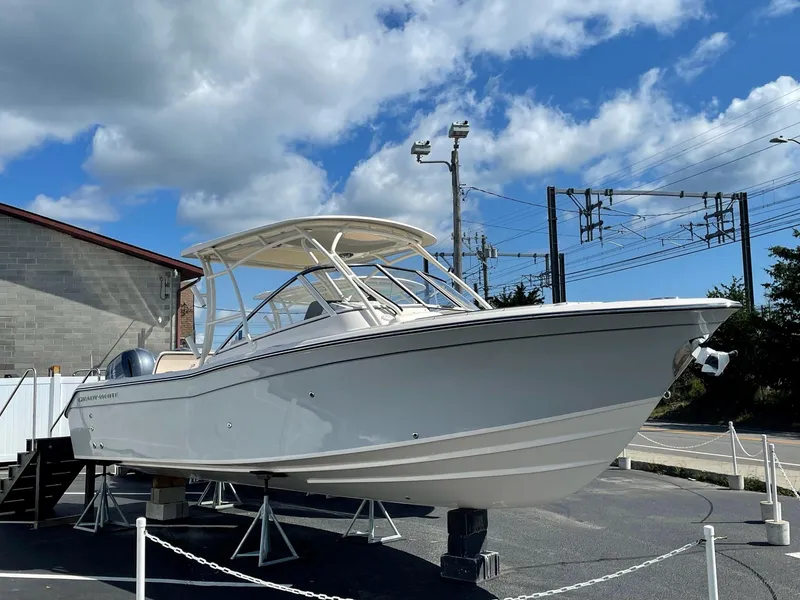 The Image of 2024 Grady-White Freedom 275 boat displayed outdoors under a blue sky. - 0