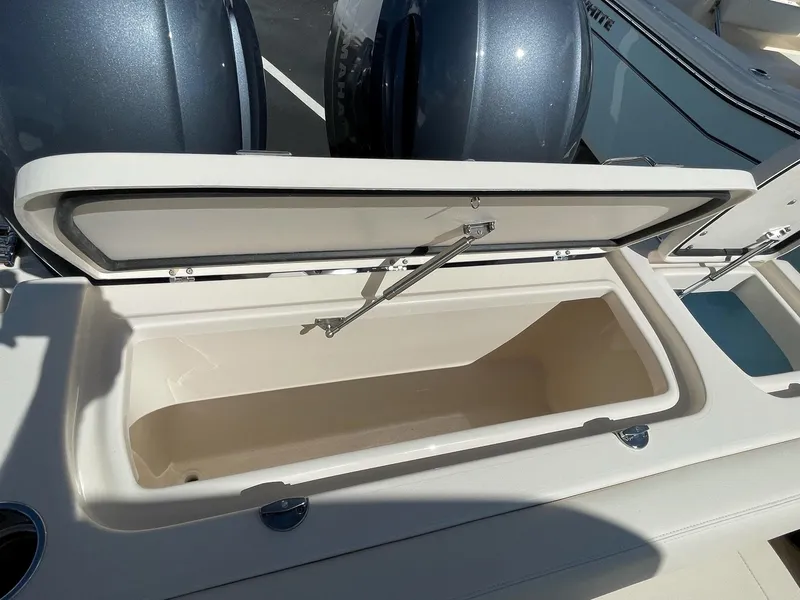 Slide: The Image of 2024 Grady-White Freedom 275 boat storage compartment with open lid. - 13