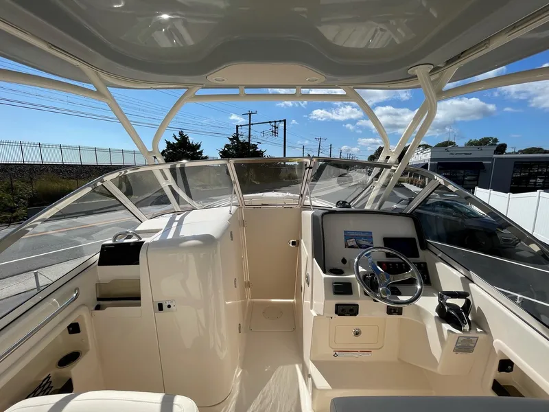 Slide: The Image of 2024 Grady-White Freedom 275 boat interior with helm and seating. - 2
