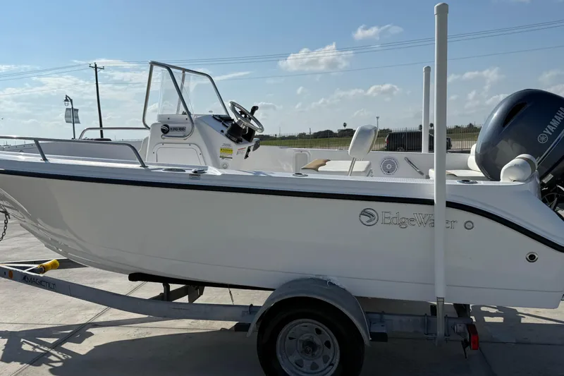 Slide: The Image of 2024 Edgewater 170CC boat on trailer, featuring Yamaha outboard motor, under clear sky. - 10