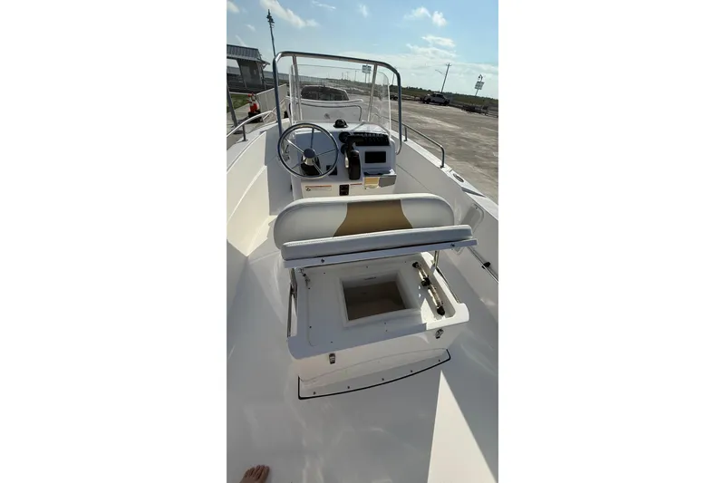 Slide: The Image of 2024 Edgewater 170CC boat interior with steering console and seating. - 18