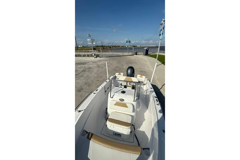 Slide: The Image of 2024 Edgewater 170CC boat at dock, featuring sleek design and spacious seating. - 20