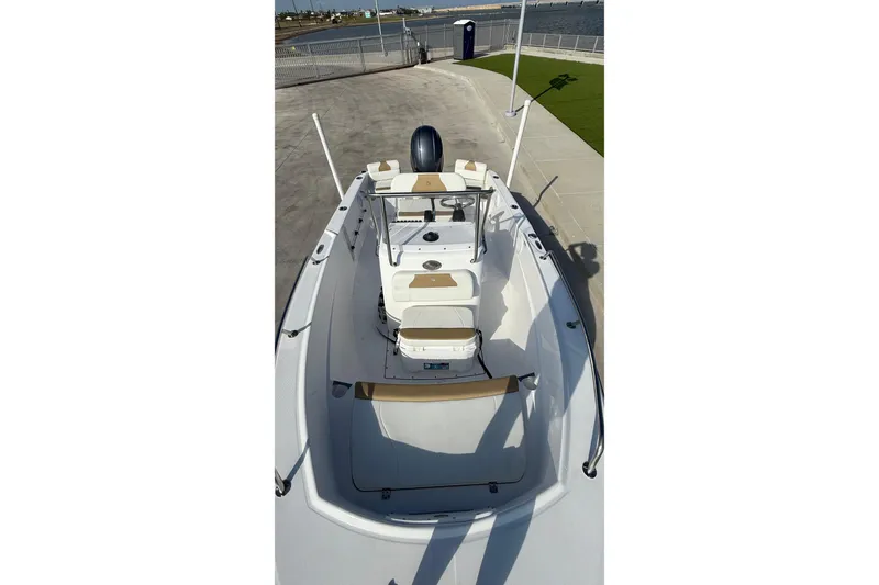 Slide: The Image of 2024 Edgewater 170CC boat, top view, docked on concrete, featuring sleek design and modern amenities. - 25