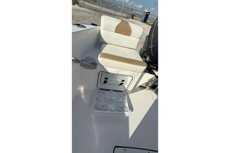 Slide: The Image of 2024 Edgewater 170CC boat interior with open storage compartment and cushioned seating. - 26