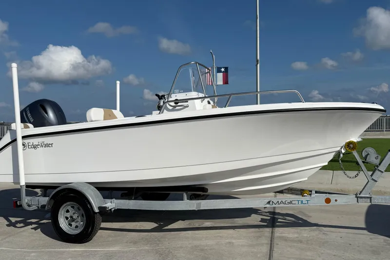Slide: The Image of 2024 Edgewater 170CC boat on trailer, clear sky background, Texas flag visible. - 7