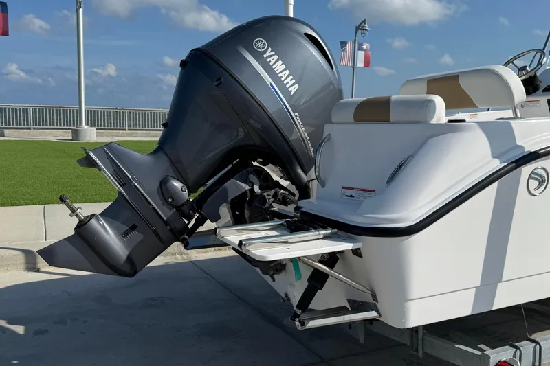 Slide: The Image of 2024 Edgewater 170CC boat with Yamaha outboard motor, docked under clear skies. - 8