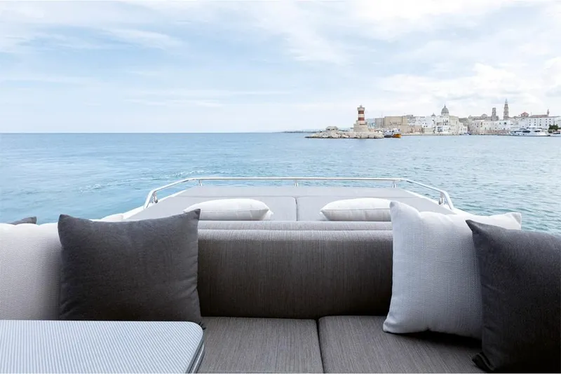 Slide: The Image of View from the Azimut S6 Sportfly 2023 yacht, overlooking the serene ocean and coastal town. - 8