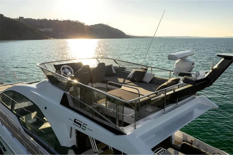 Slide: The Image of 2023 Azimut S6 Sportfly yacht on serene water at sunset. - 9