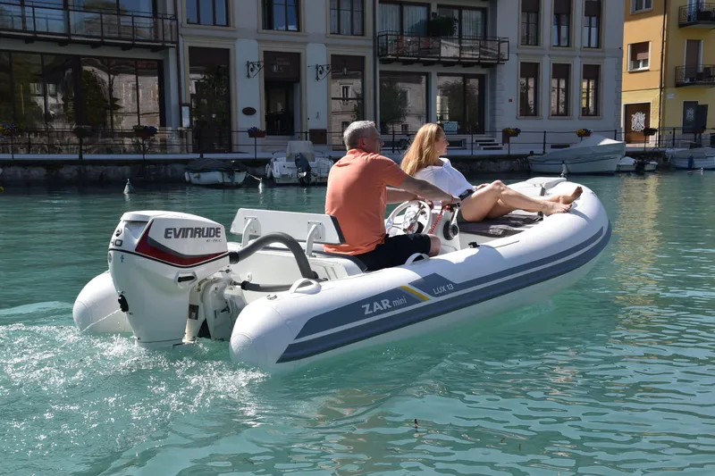 The Image of 2023 ZAR Mini LUX 13 inflatable boat cruising on clear water. - 1