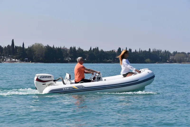 Slide: The Image of 2023 ZAR Mini LUX 13 inflatable boat on water with two passengers. - 6