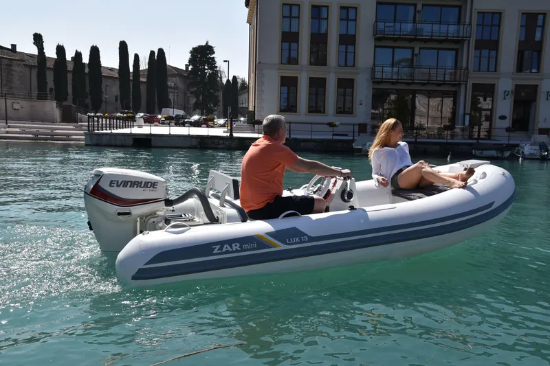 Slide: The Image of 2023 ZAR Mini LUX 13 inflatable boat cruising on clear water. - 8