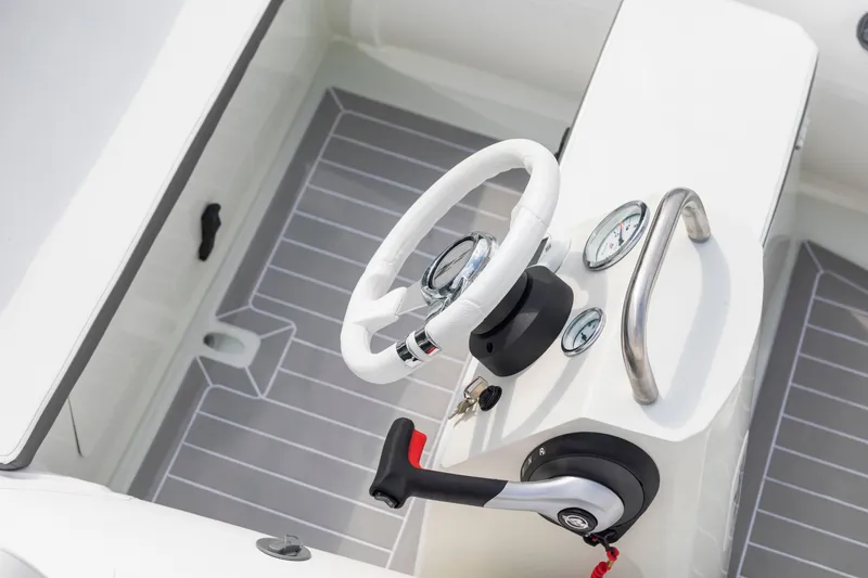 Slide: The Image of 2023 ZAR Mini LUX 12 boat cockpit with steering wheel and control panel. - 2