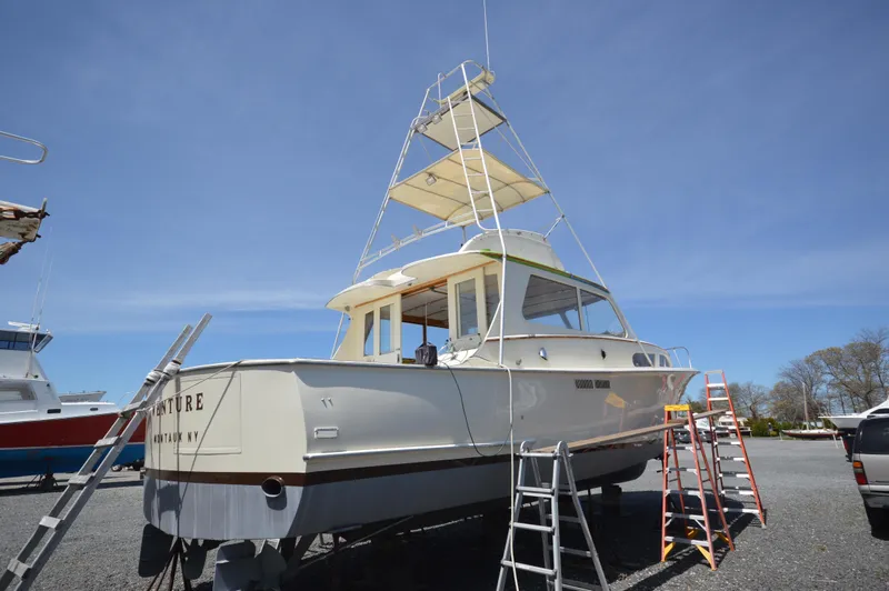 Slide: The Image of 1961 Hatteras 41 Convertible boat on dry dock with ladders for maintenance. - 10