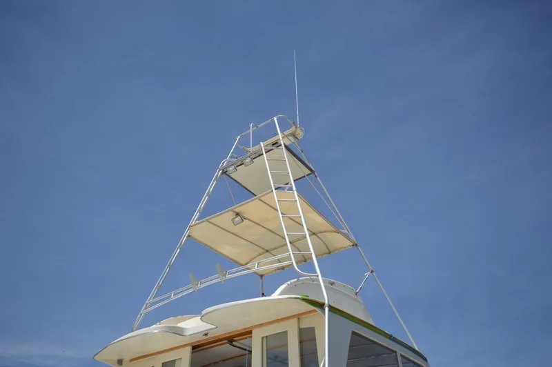 Slide: The Image of Top view of a 1961 Hatteras 41 Convertible boat against a clear blue sky. - 11