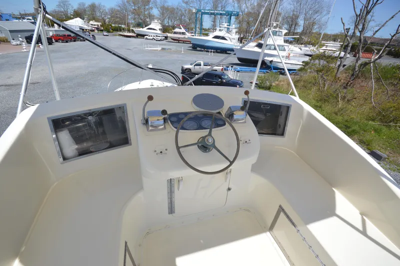 Slide: The Image of 1961 Hatteras 41 Convertible boat helm with steering wheel and controls. - 13