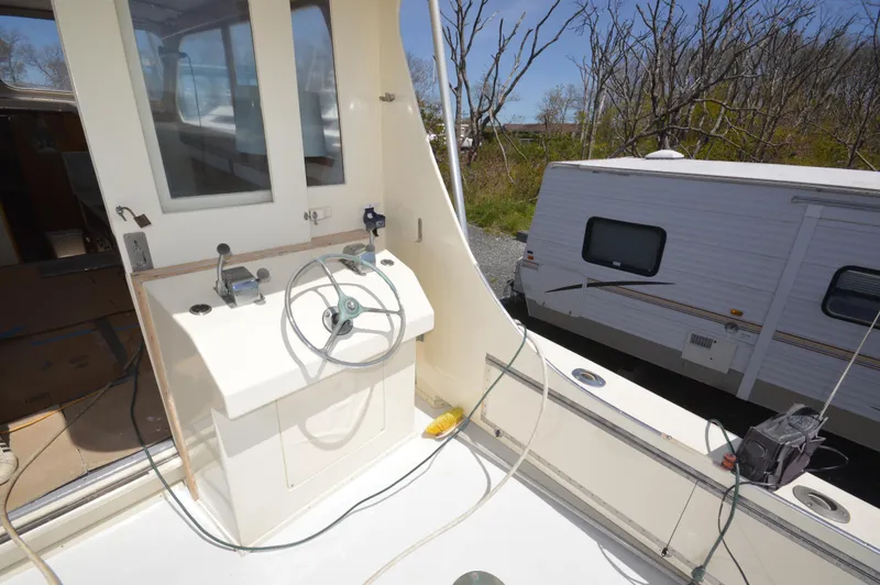 Slide: The Image of 1961 Hatteras 41 Convertible boat helm station with steering wheel and controls. - 15