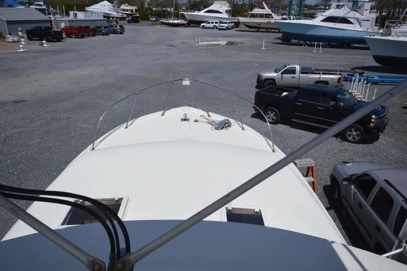 Slide: The Image of View from the bow of a 1961 Hatteras 41 Convertible yacht in a boatyard. - 17