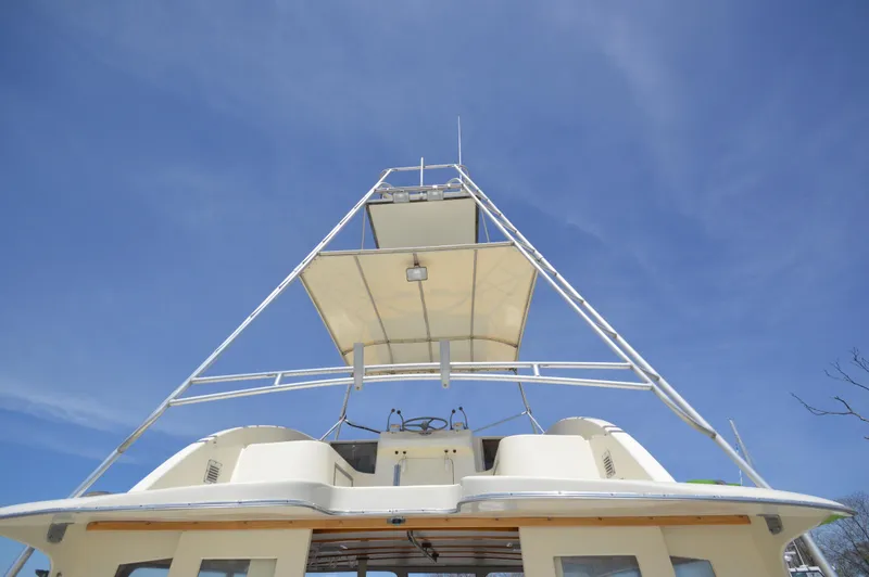 Slide: The Image of 1961 Hatteras 41 Convertible boat with flybridge against a clear blue sky. - 18