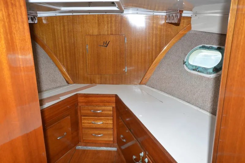 Slide: The Image of 1961 Hatteras 41 Convertible yacht interior with wooden cabinetry and porthole window. - 19
