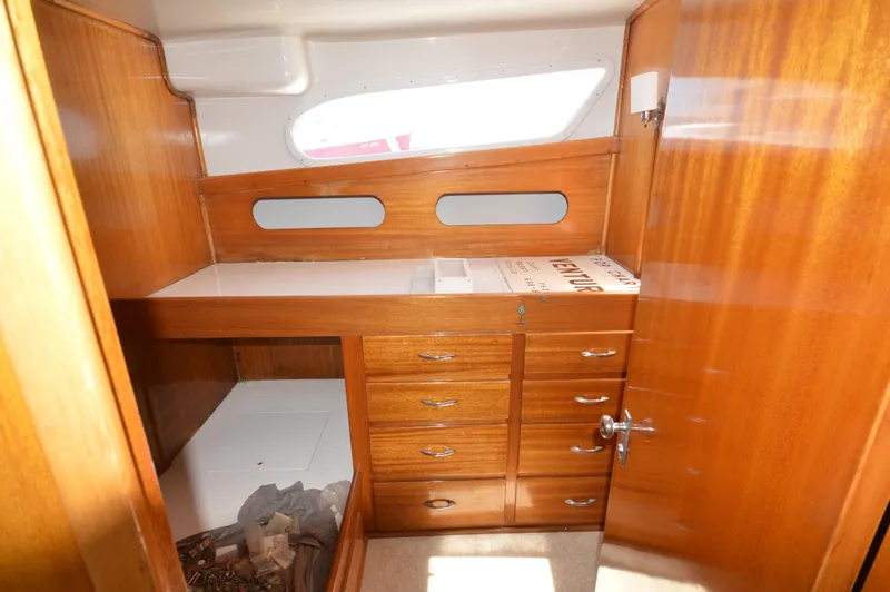 Slide: The Image of 1961 Hatteras 41 Convertible cabin with wooden cabinetry and storage drawers. - 21