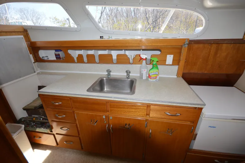 Slide: The Image of 1961 Hatteras 41 Convertible kitchen with wooden cabinets and stainless steel sink. - 22