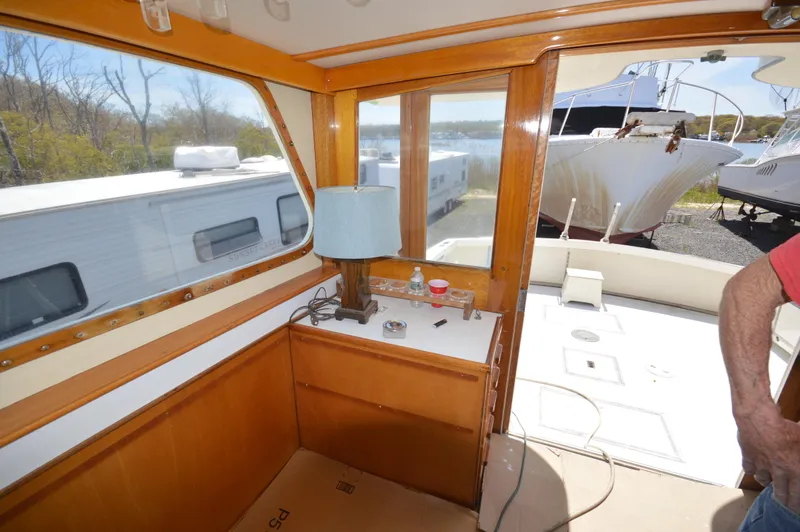 Slide: The Image of Interior view of 1961 Hatteras 41 Convertible yacht with wooden cabinetry and large windows. - 26